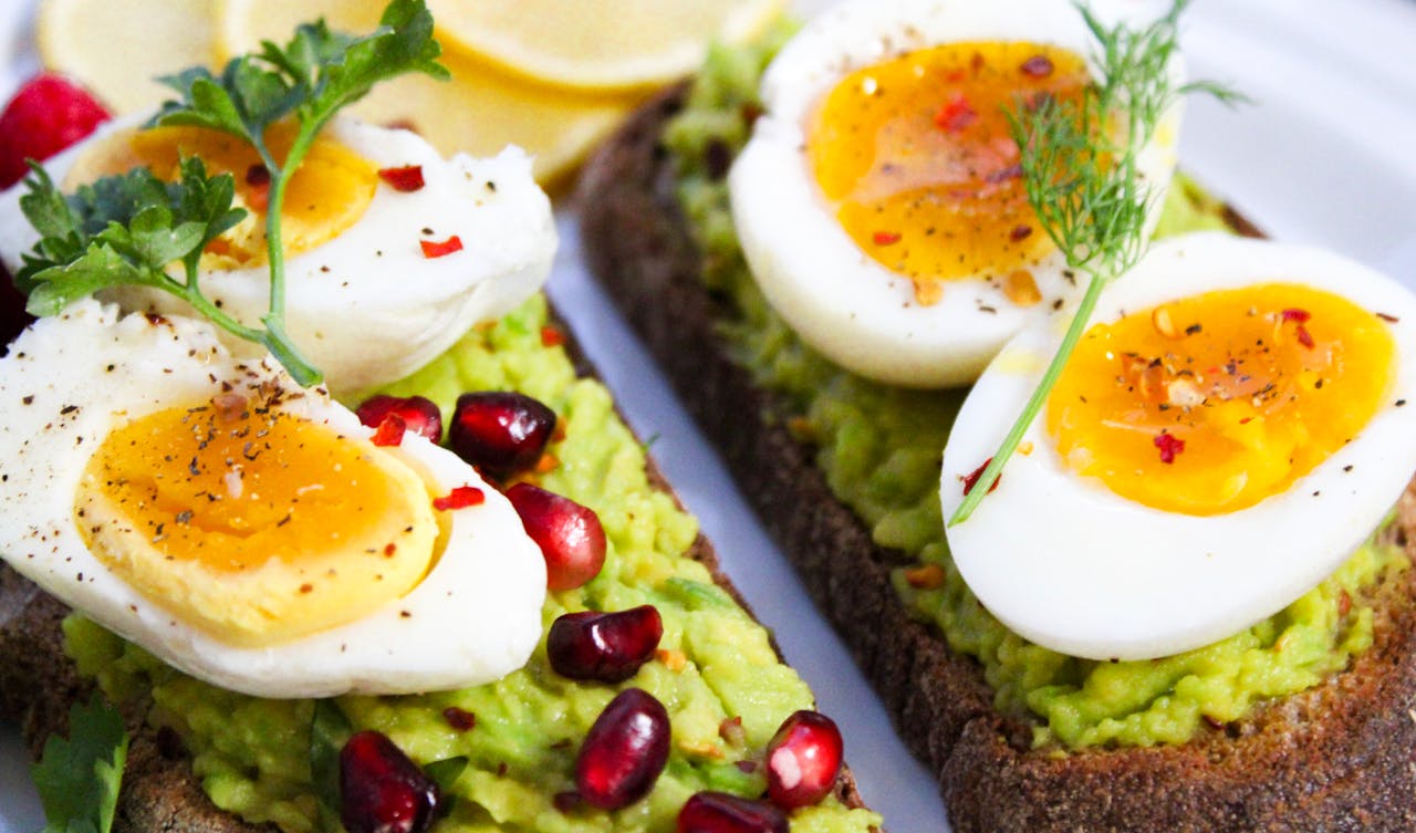 gallery-05 Savor this delicious avocado toast topped with soft-boiled eggs and garnished with pomegranate seeds.